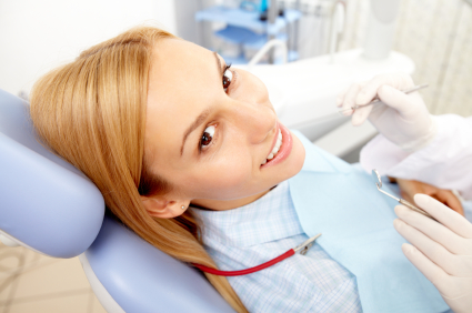 Woman sitting in a dental chair smiling at the camera