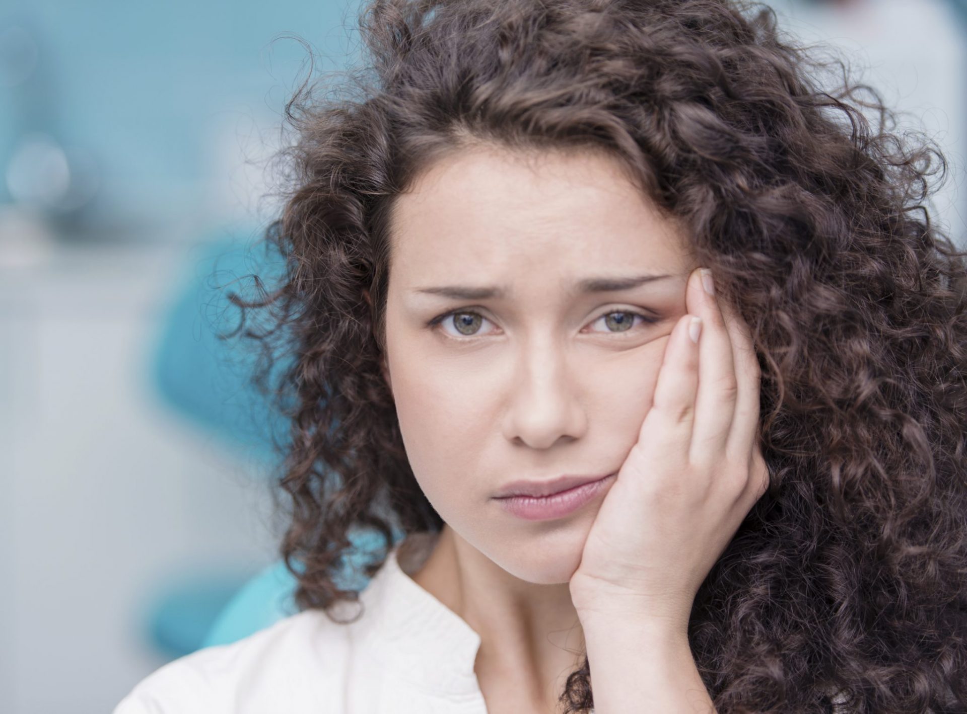 Young woman suffering from toothache