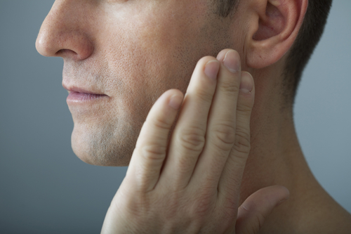 Man holding his jaw