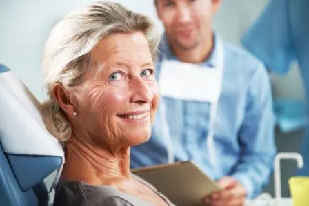senior woman in dental chair smiling