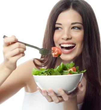 Attractive woman eating a salad