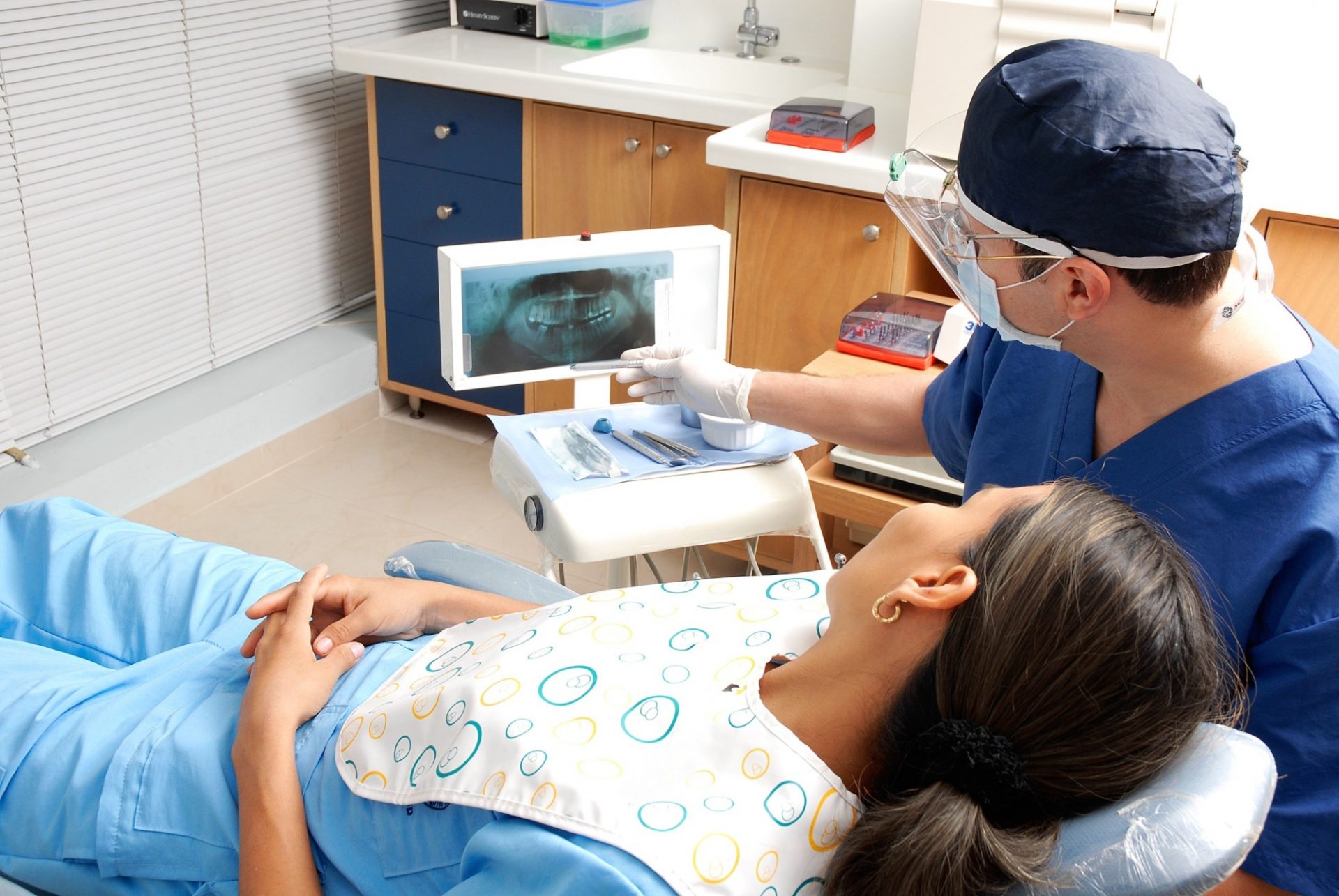 Periodontist in Phoenix, AZ, showing a patient their x-rays