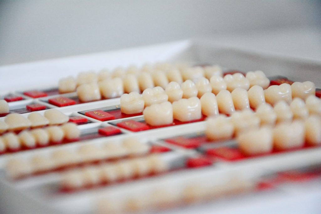 Natural looking dental crowns on a tray
