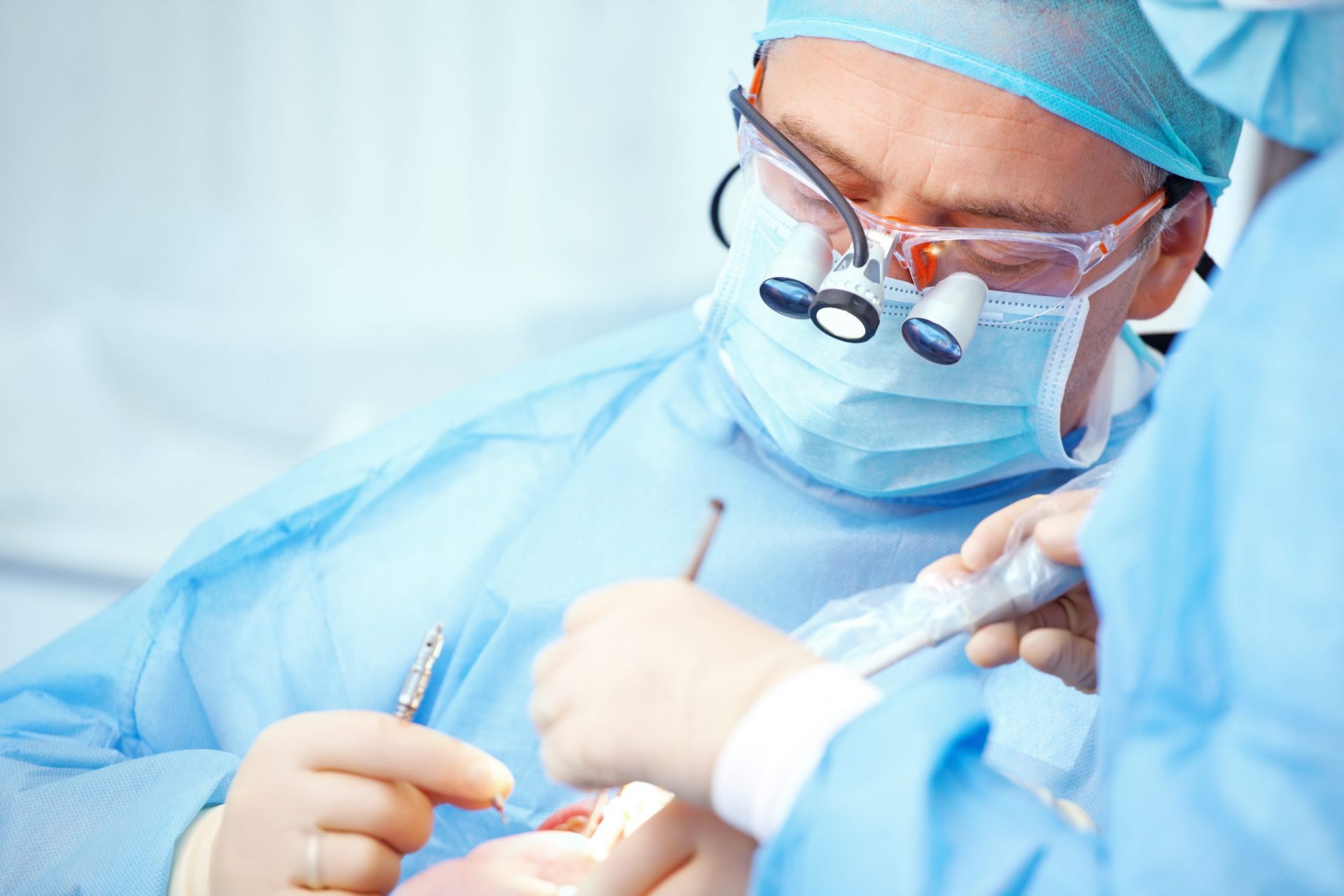 A periodontist operating on a patient.