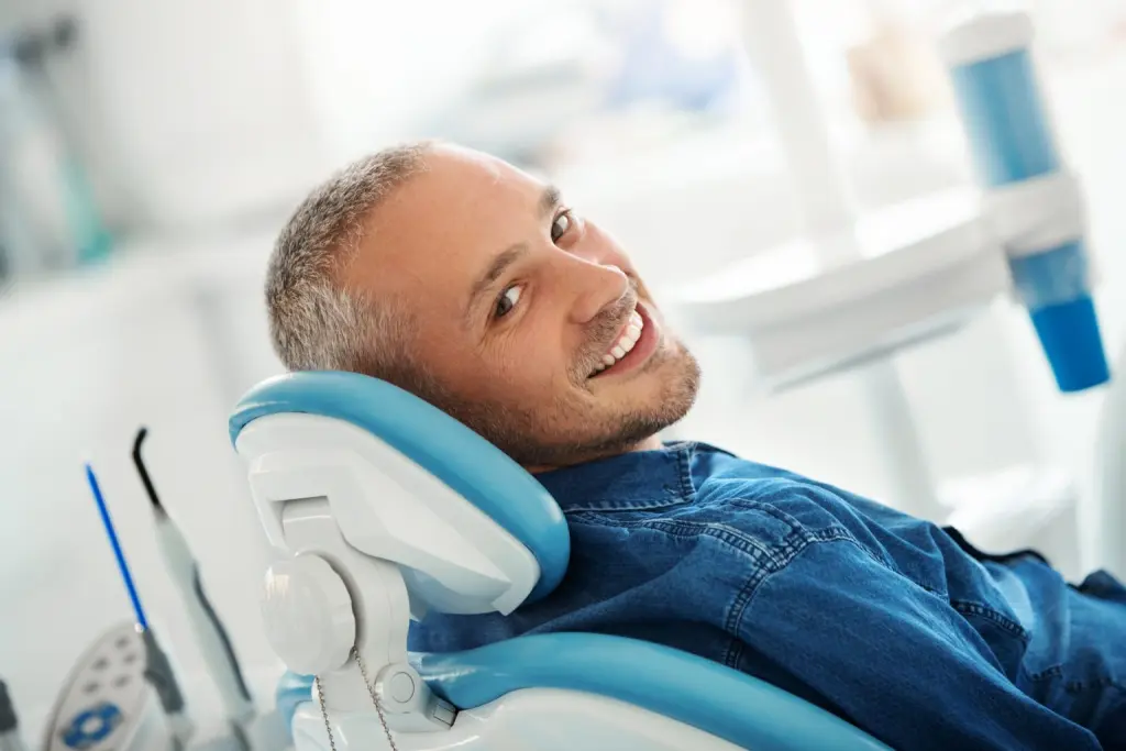 Man getting checked for loose teeth