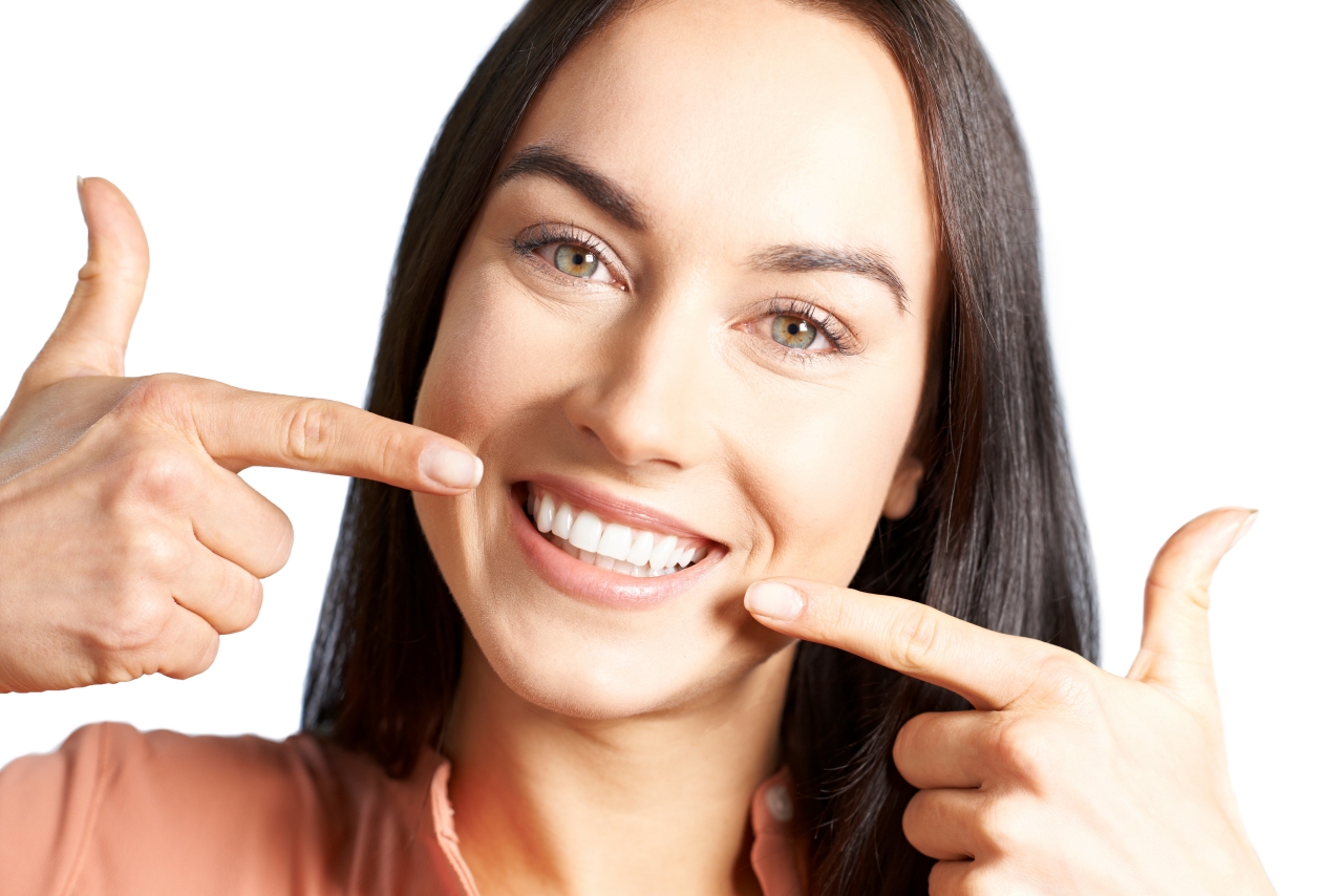 Woman pointing to her perfect teeth and gums