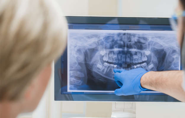 a periodontist and patient looking at an X-ray.
