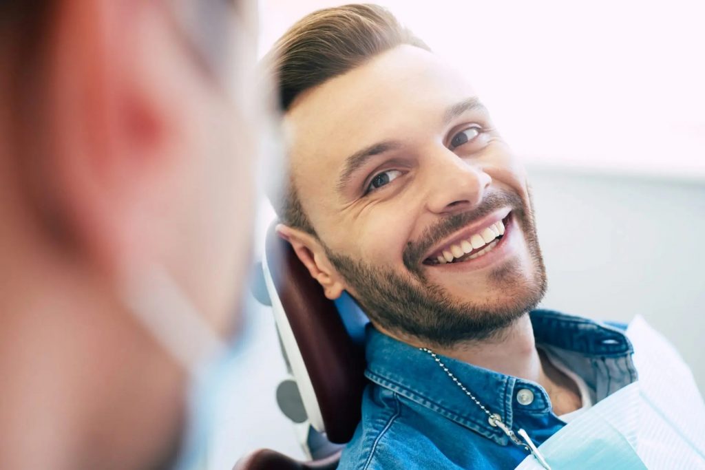 Man in dental chair smiling