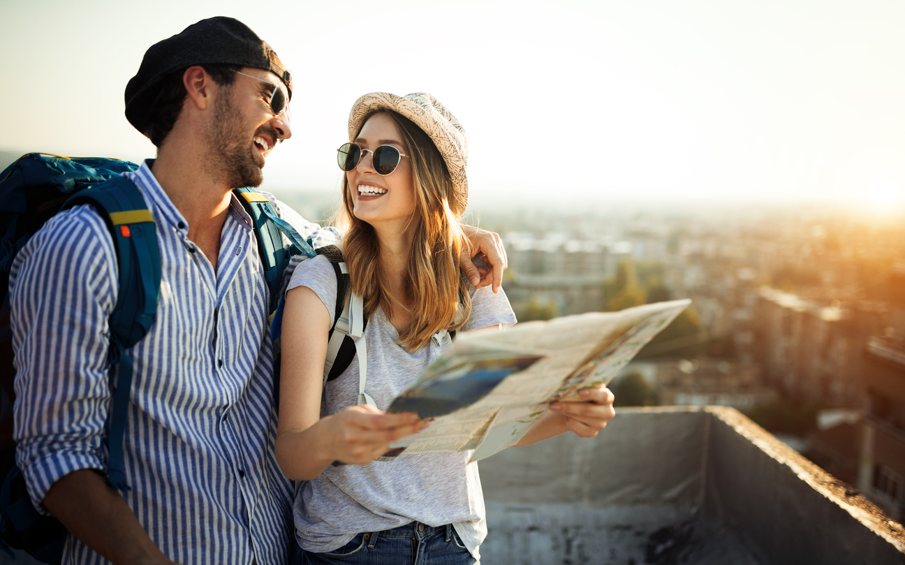 Young couple traveling with a map in the city