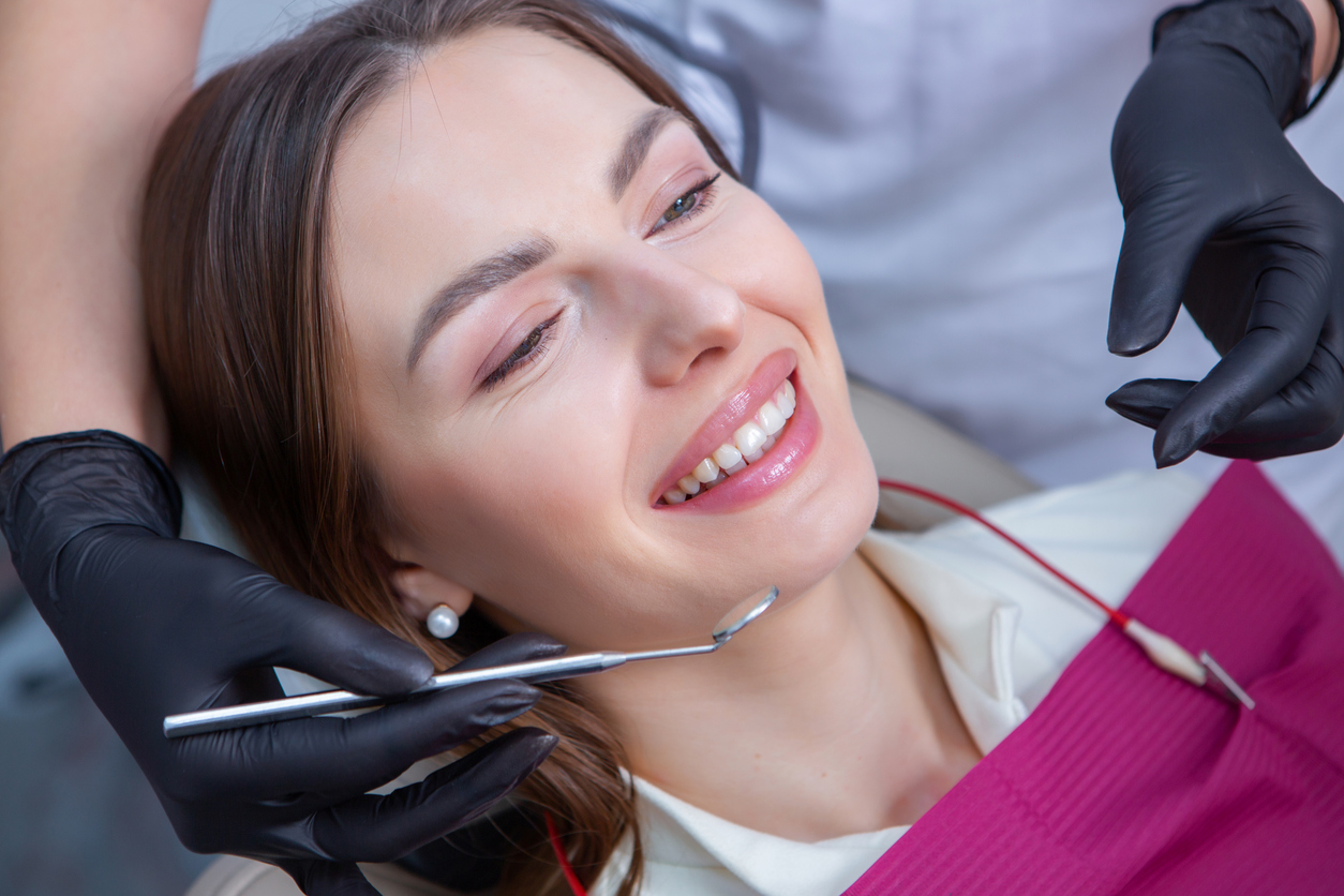 happy female dental patient deep cleaning.