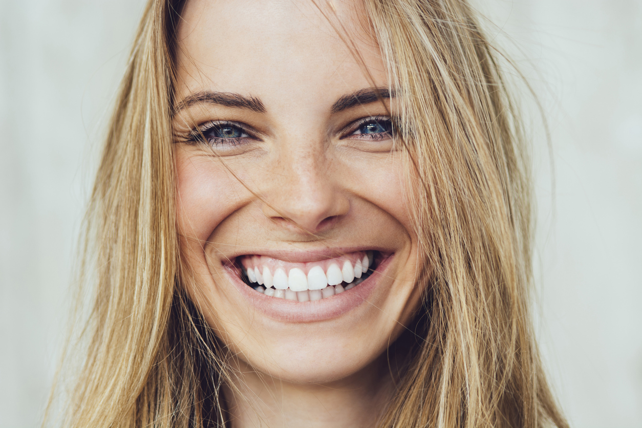 Gum recession prevention. Woman with healthy gums smiling.