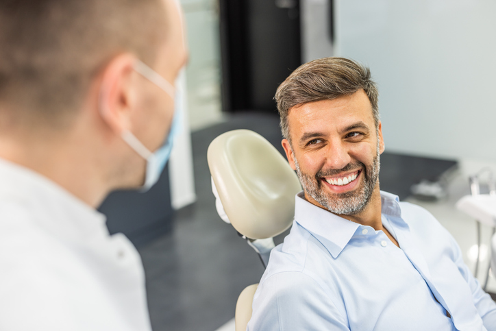 Male gum recession patient getting pinhole gum surgery.