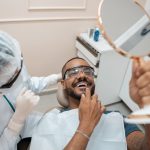 Patient checking the result of Pinhole gum treatment