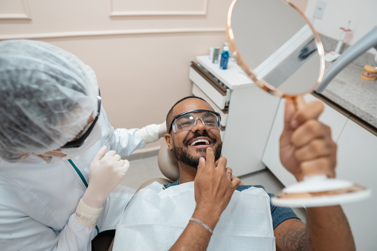 Patient checking the result of Pinhole gum treatment