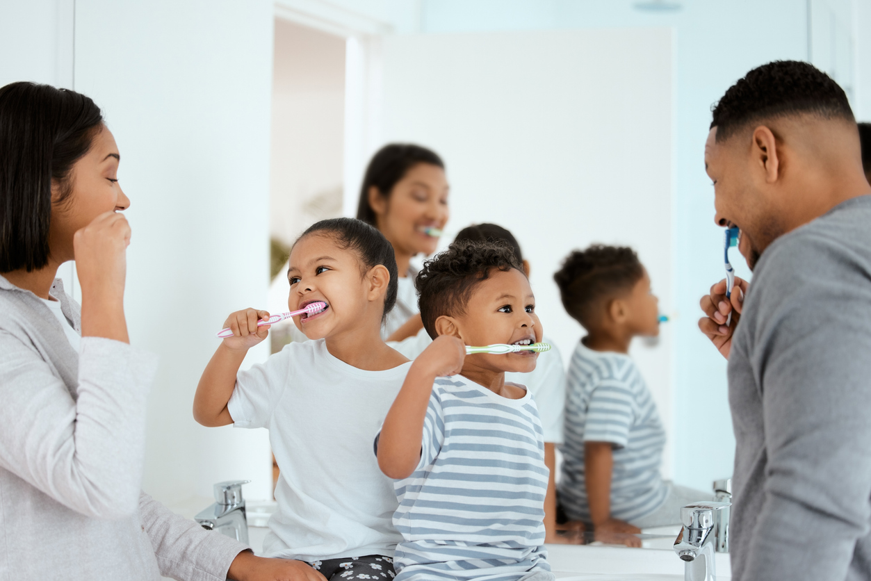 a family brushing their teeth together
